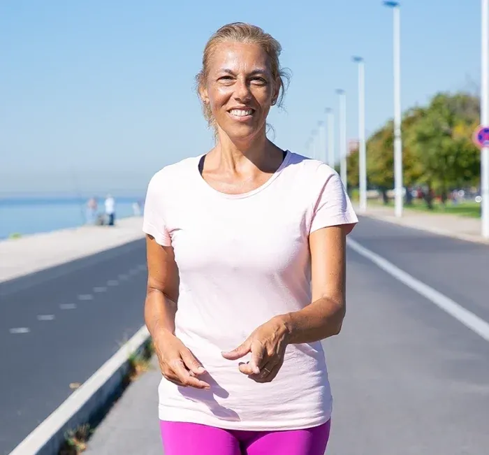 A woman walking on a seaside path